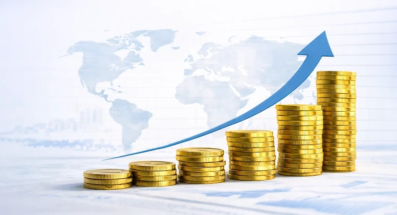 Steigende Münzstapel mit Aufwärtspfeil vor Weltkarte, Finanzwachstum